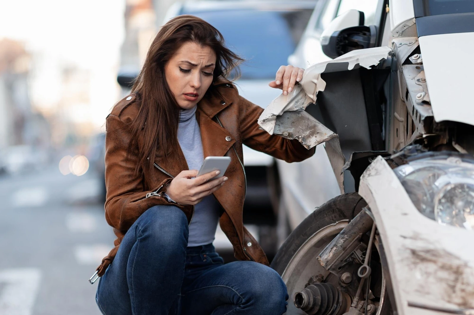 A driver documenting the scene after a collision